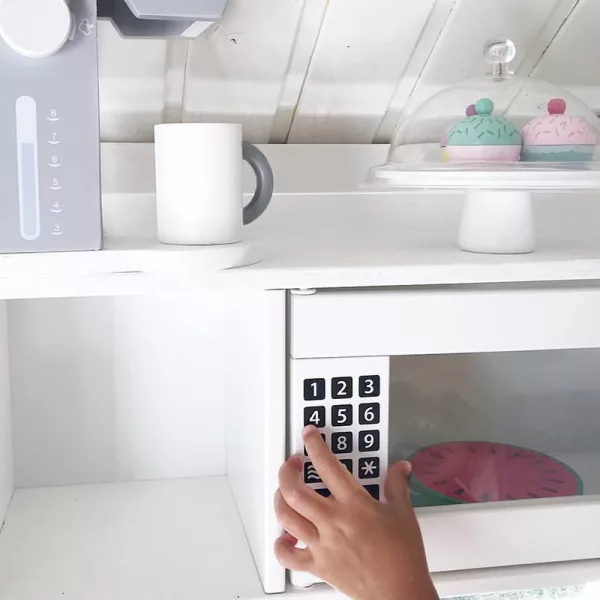 Eager little fingers adjust the microwave!
